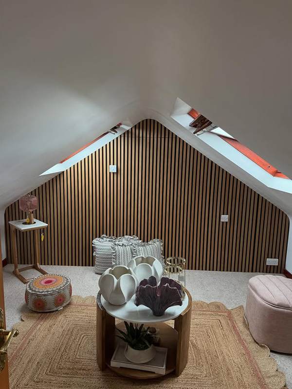 Vertical acoustic wall panelling in an attic bedroom