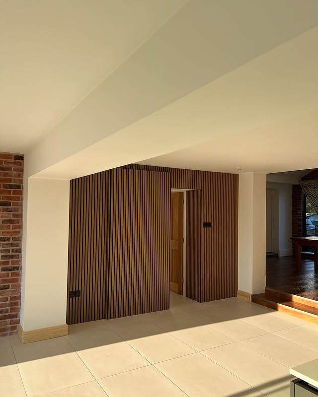Fluted panelled wall with a hidden sliding door