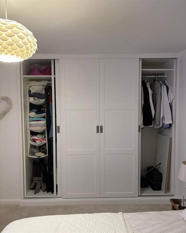 White sliding wardrobe doors beside a freshly carpeted bedroom